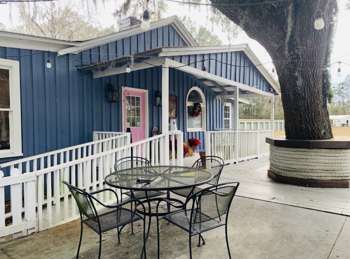 Barraco's shaded patio and porch beside the live oak